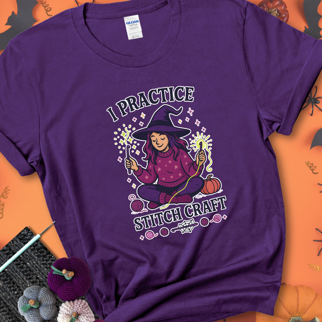 Purple t-shirt with a witchy crocheter conjuring glowing yarn with crochet hooks, surrounded by stars and pumpkins, with the phrase “I Practice Stitch Craft.”
