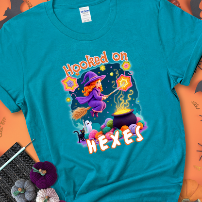 Tropical Blue t-shirt with stars, hexagon motifs, and a crochet hook, with text reading “Hooked on Hexes.”
