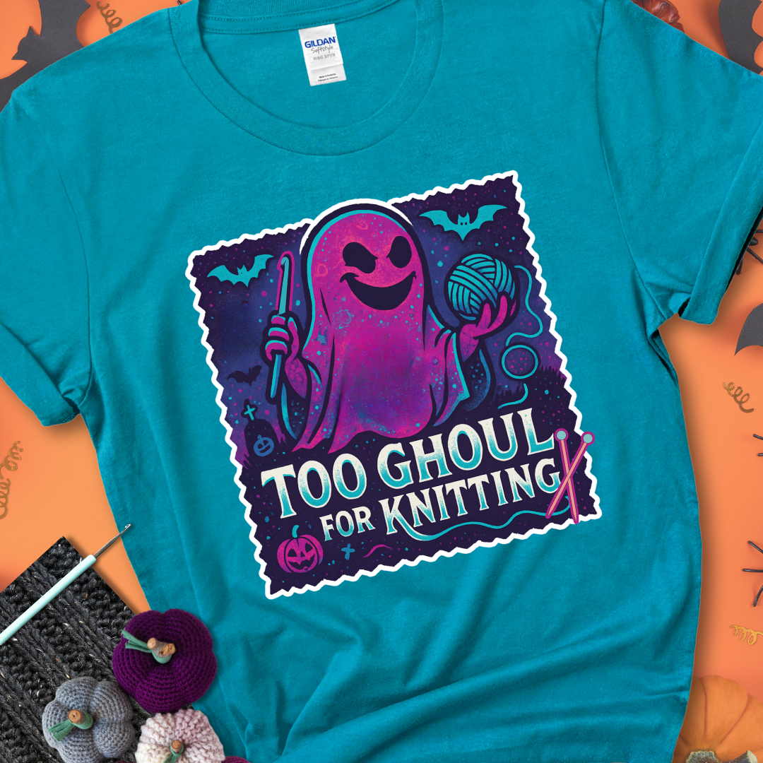 Tropical blue t-shirt with a ghost holding a crochet hook and ball of yarn, with the phrase “Too Ghoul for Knitting” in purple, teal, and white.