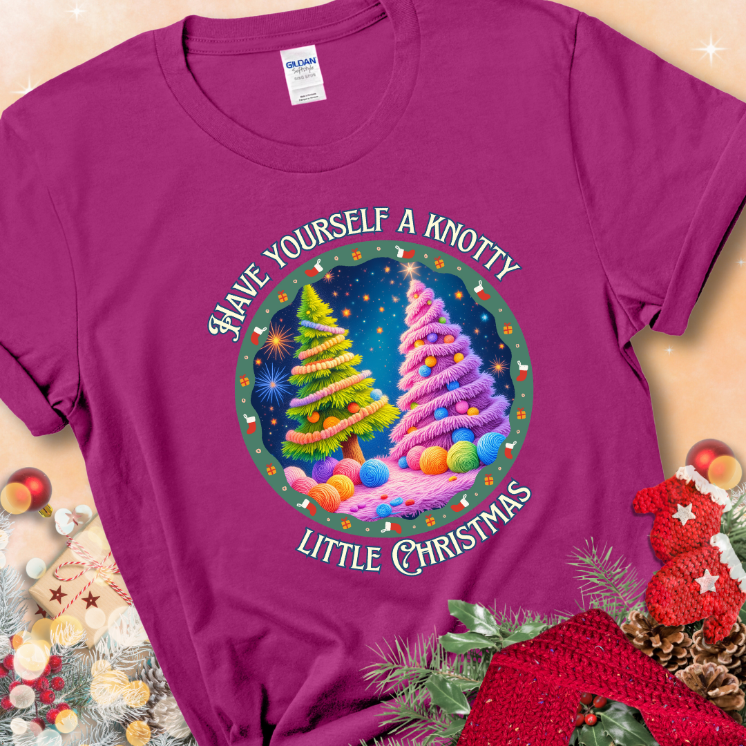 Antique Heliconia t-shirt with two yarn-covered Christmas trees wrapped in colorful strands of yarn, encircled by the phrase “Have Yourself A Knotty Little Christmas.”