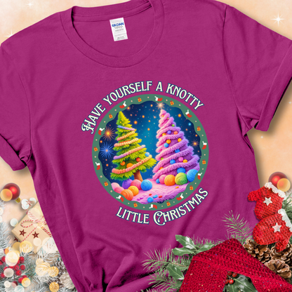 Antique Heliconia t-shirt with two yarn-covered Christmas trees wrapped in colorful strands of yarn, encircled by the phrase “Have Yourself A Knotty Little Christmas.”