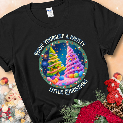 Black t-shirt with two yarn-covered Christmas trees wrapped in colorful strands of yarn, encircled by the phrase “Have Yourself A Knotty Little Christmas.”