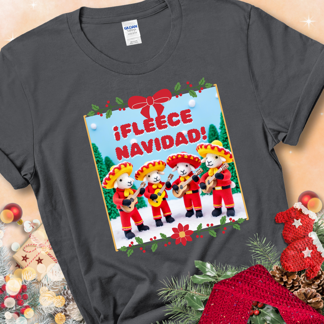 Charcoal t-shirt with four crocheted sheep in red mariachi outfits holding guitars, standing in a snowy scene under the phrase “¡Fleece Navidad!”