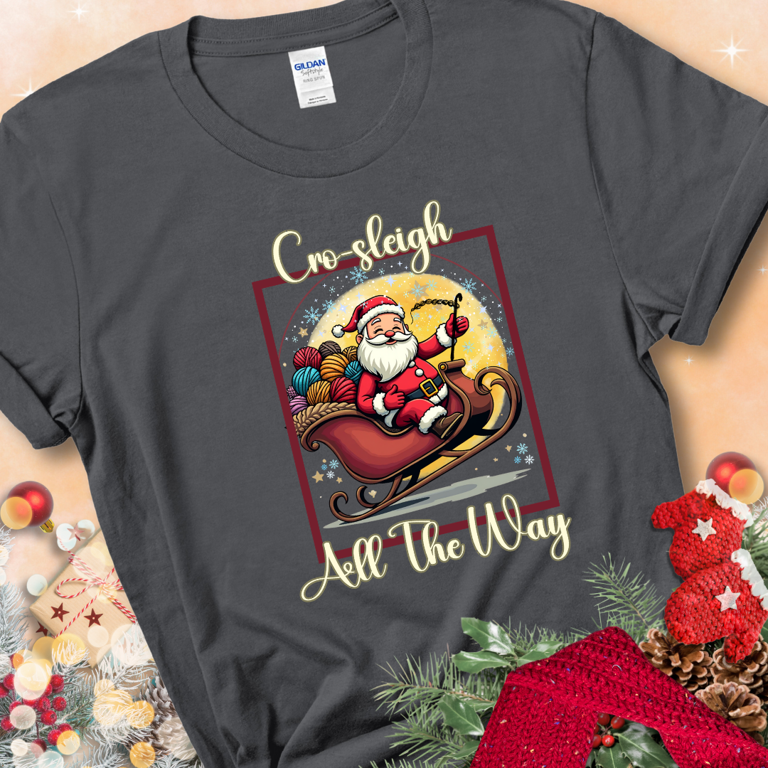 Charcoal t-shirt with Santa riding in a sleigh overflowing with colorful yarn and the phrase “Cro-Sleigh All The Way.”