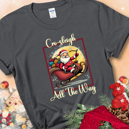 Charcoal t-shirt with Santa riding in a sleigh overflowing with colorful yarn and the phrase “Cro-Sleigh All The Way.”