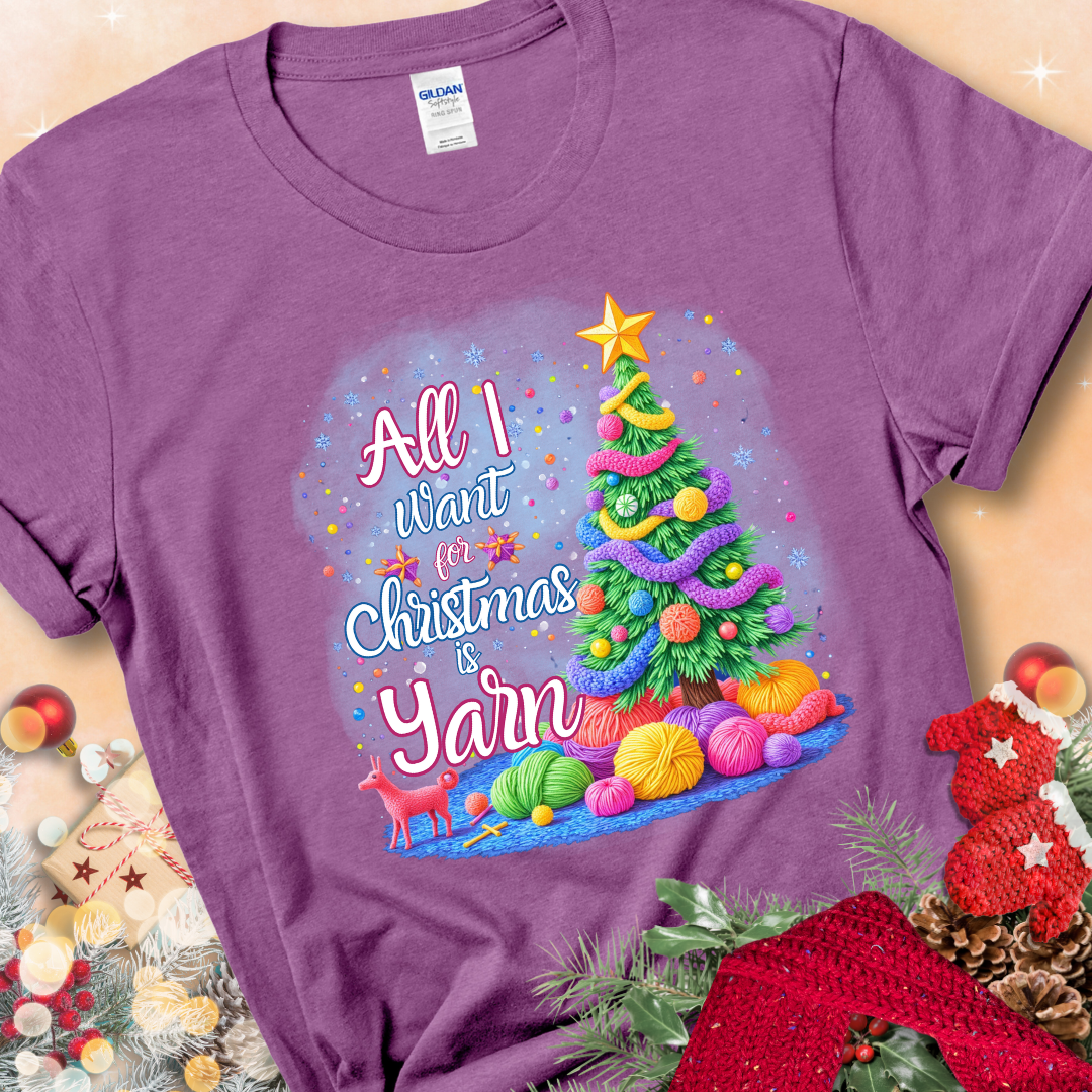 Heather Radiant Orchid t-shirt with a colorful Christmas tree decorated with yarn and the phrase “All I Want For Christmas Is Yarn.”