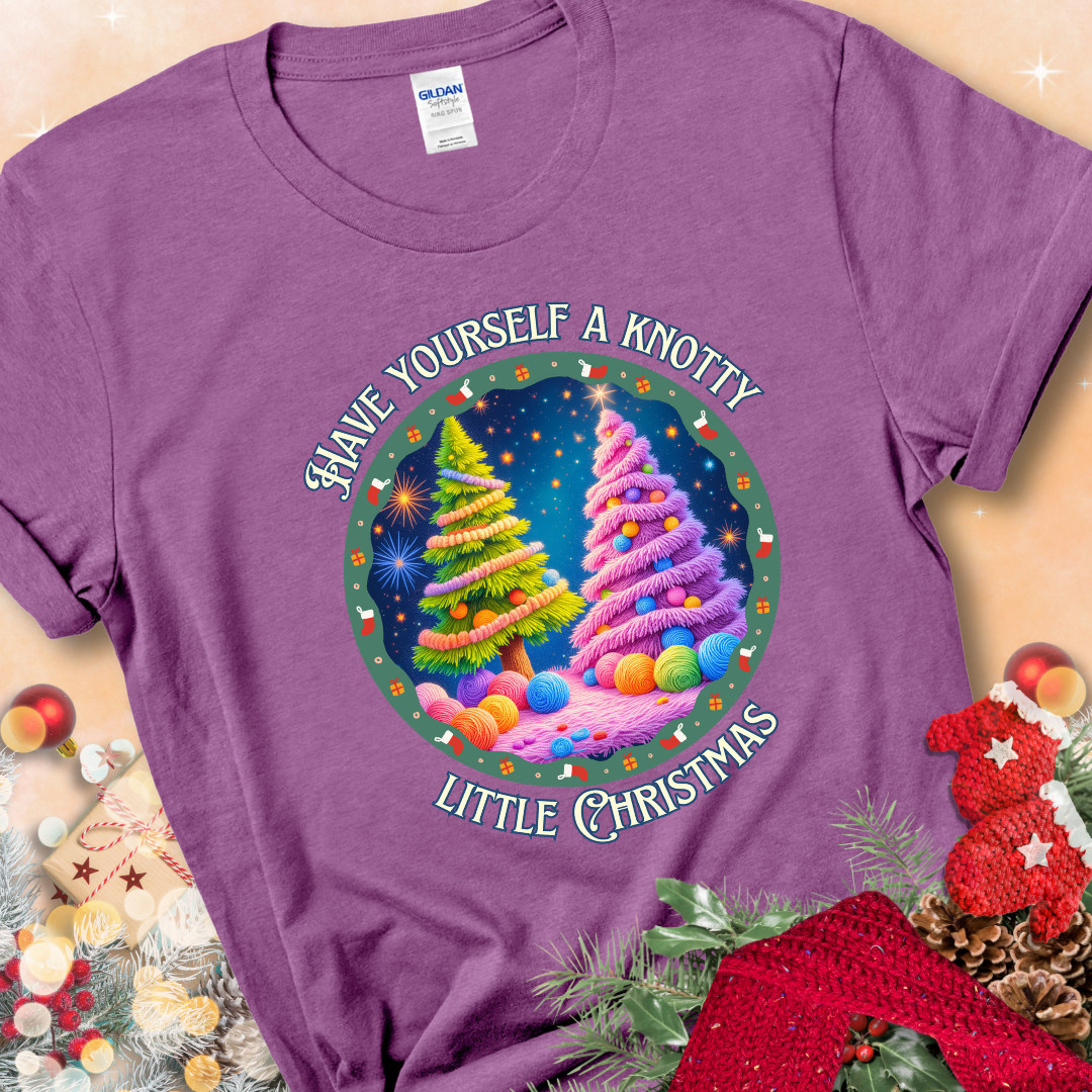 Heather Radiant Orchid t-shirt with two yarn-covered Christmas trees wrapped in colorful strands of yarn, encircled by the phrase “Have Yourself A Knotty Little Christmas.”