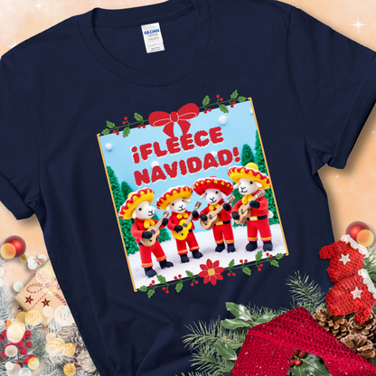 Navy t-shirt with four crocheted sheep in red mariachi outfits holding guitars, standing in a snowy scene under the phrase “¡Fleece Navidad!”