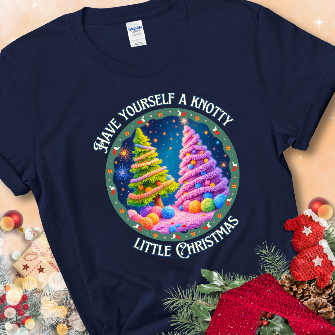 Navy t-shirt with two yarn-covered Christmas trees wrapped in colorful strands of yarn, encircled by the phrase “Have Yourself A Knotty Little Christmas.”