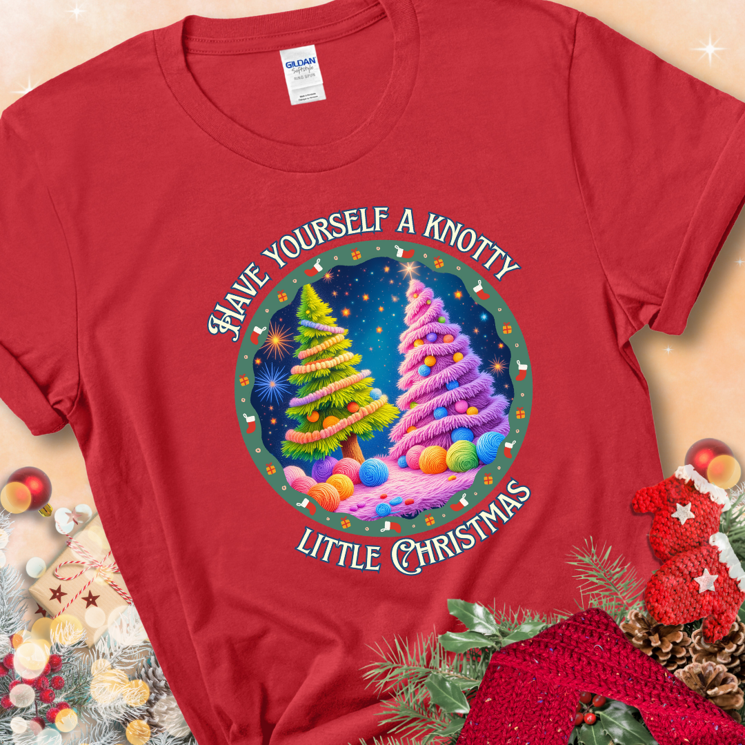 Red t-shirt with two yarn-covered Christmas trees wrapped in colorful strands of yarn, encircled by the phrase “Have Yourself A Knotty Little Christmas.”