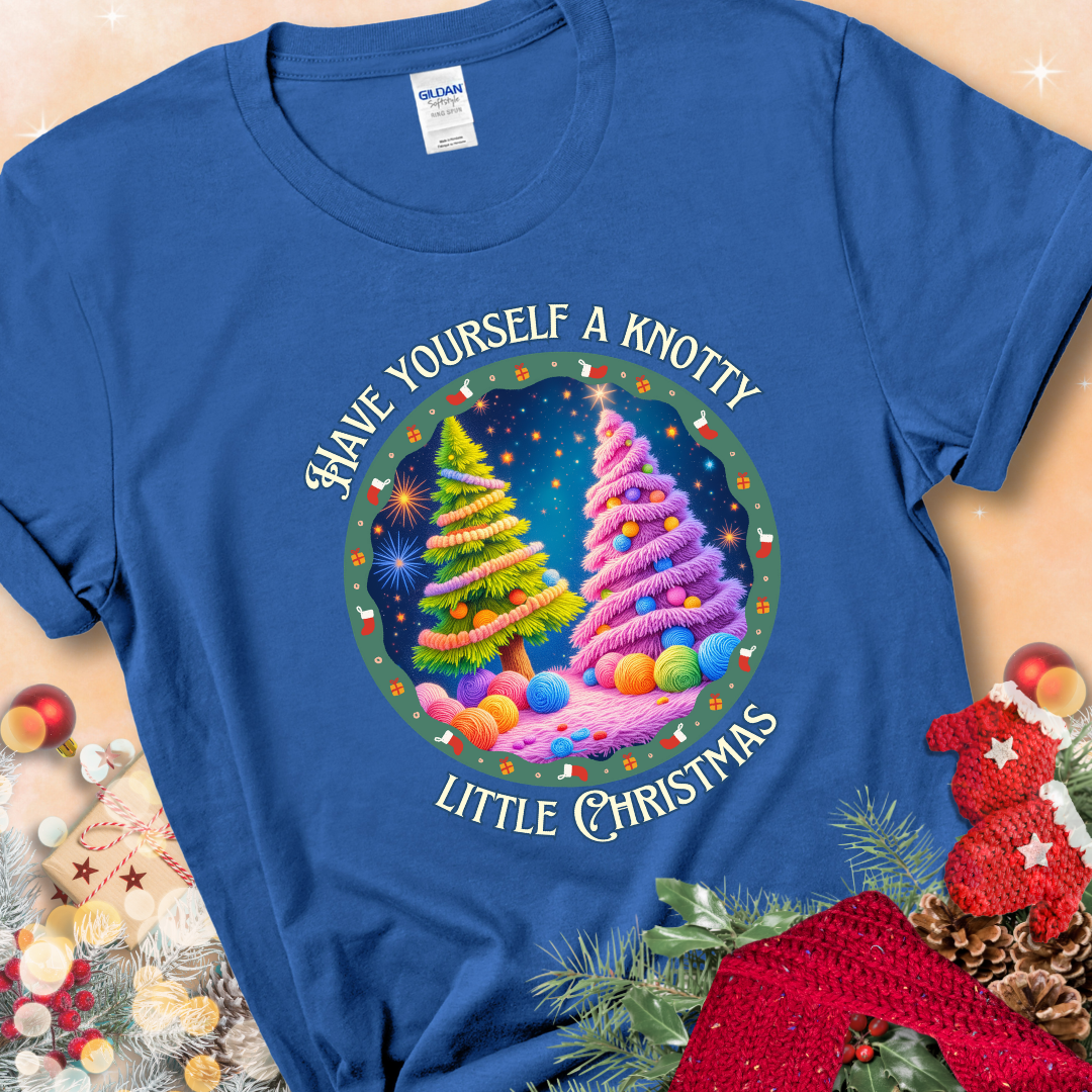 Royal Blue t-shirt with two yarn-covered Christmas trees wrapped in colorful strands of yarn, encircled by the phrase “Have Yourself A Knotty Little Christmas.”