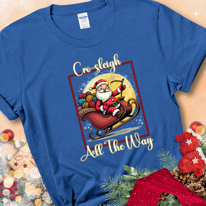 Royal Blue t-shirt with Santa riding in a sleigh overflowing with colorful yarn and the phrase “Cro-Sleigh All The Way.”