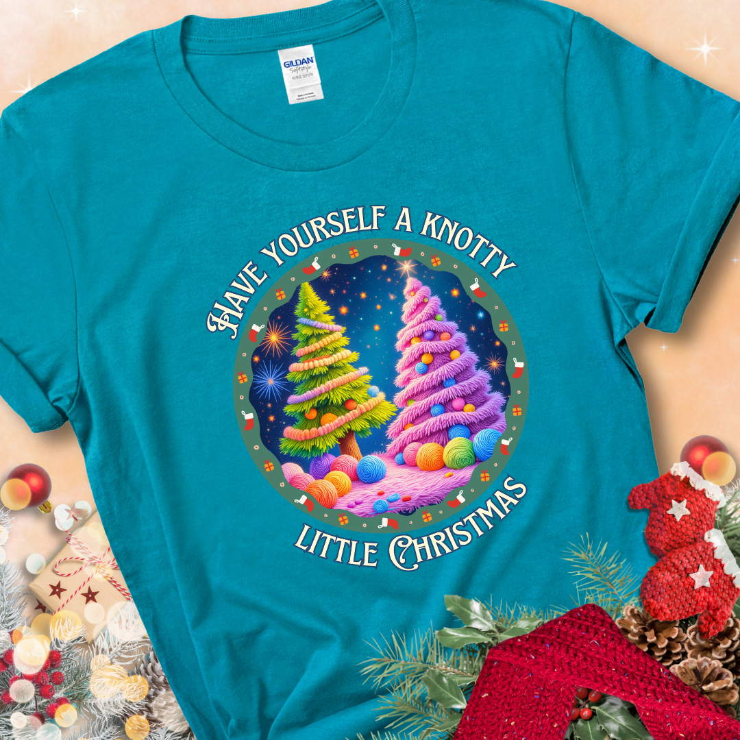 Tropical Blue t-shirt with two yarn-covered Christmas trees wrapped in colorful strands of yarn, encircled by the phrase “Have Yourself A Knotty Little Christmas.”