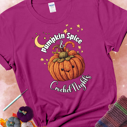 Antique heliconia t-shirt with a smiling pumpkin crocheted with yarn texture, surrounded by stars and a crescent moon. Text reads “Pumpkin Spice & Crochet Nights.”