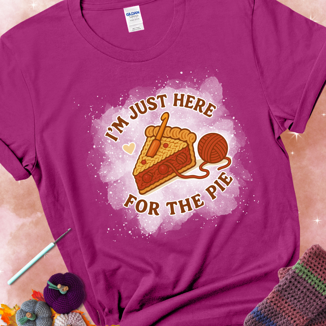 Antique Heliconia t-shirt with a stitched slice of cherry pie with yarn-inspired filling and the phrase “I’m Just Here for the Pie” in red, beige, and cream.