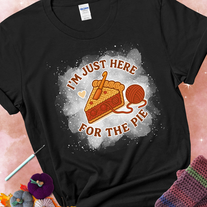 Black t-shirt with a stitched slice of cherry pie with yarn-inspired filling and the phrase “I’m Just Here for the Pie” in red, beige, and cream.