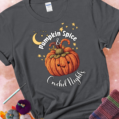 Charcoal t-shirt with a smiling pumpkin crocheted with yarn texture, surrounded by stars and a crescent moon. Text reads “Pumpkin Spice & Crochet Nights.”