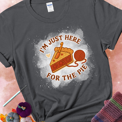 Charcoal t-shirt with a stitched slice of cherry pie with yarn-inspired filling and the phrase “I’m Just Here for the Pie” in red, beige, and cream.