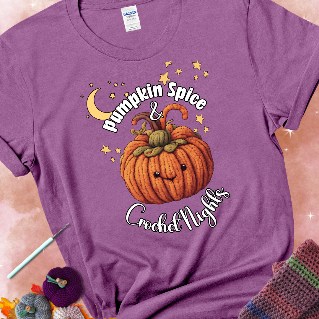 Heather radiant orchid t-shirt with a smiling pumpkin crocheted with yarn texture, surrounded by stars and a crescent moon. Text reads “Pumpkin Spice & Crochet Nights.”