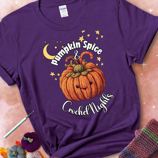 Purple t-shirt with a smiling pumpkin crocheted with yarn texture, surrounded by stars and a crescent moon. Text reads “Pumpkin Spice & Crochet Nights.”