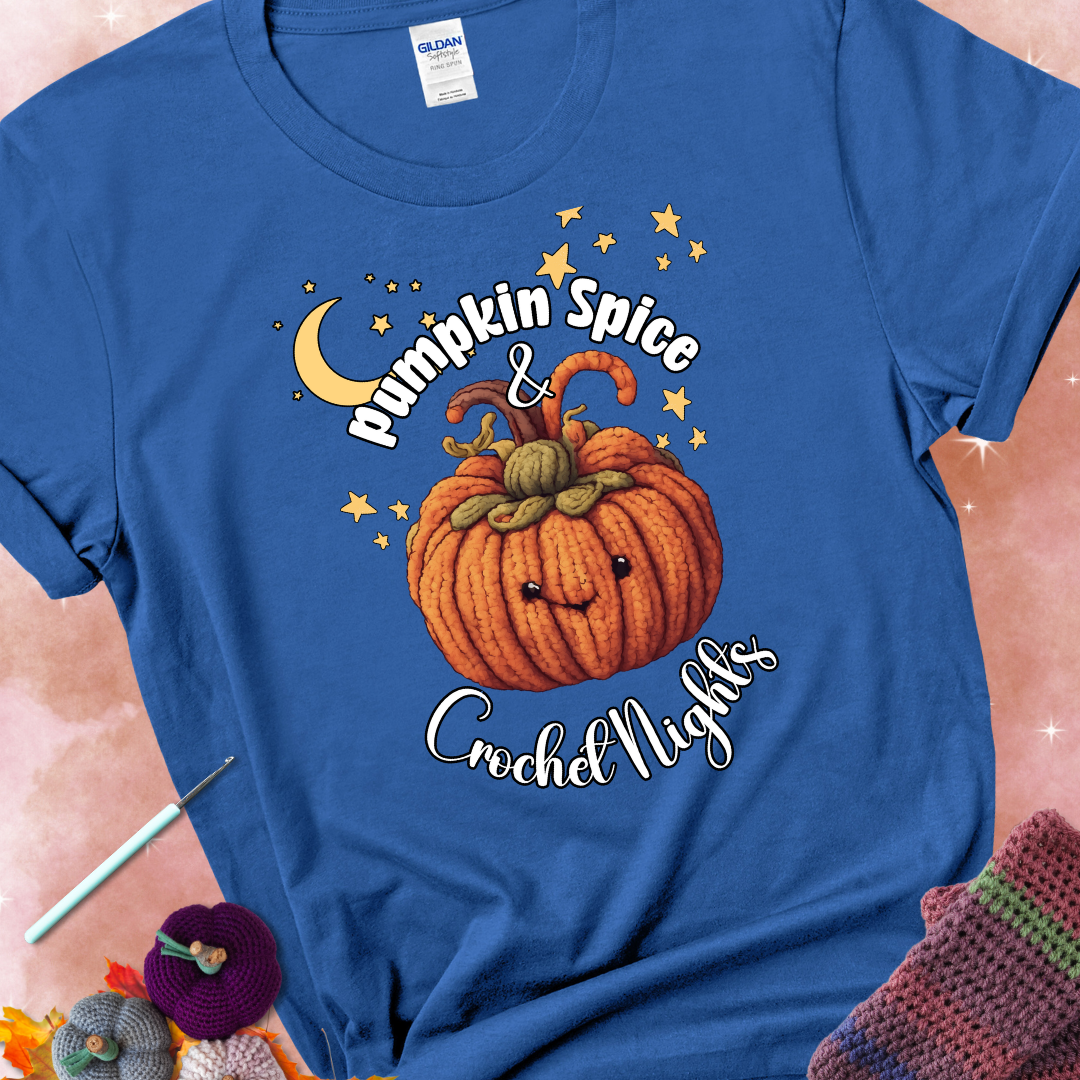 Royal blue t-shirt with a smiling pumpkin crocheted with yarn texture, surrounded by stars and a crescent moon. Text reads “Pumpkin Spice & Crochet Nights.”