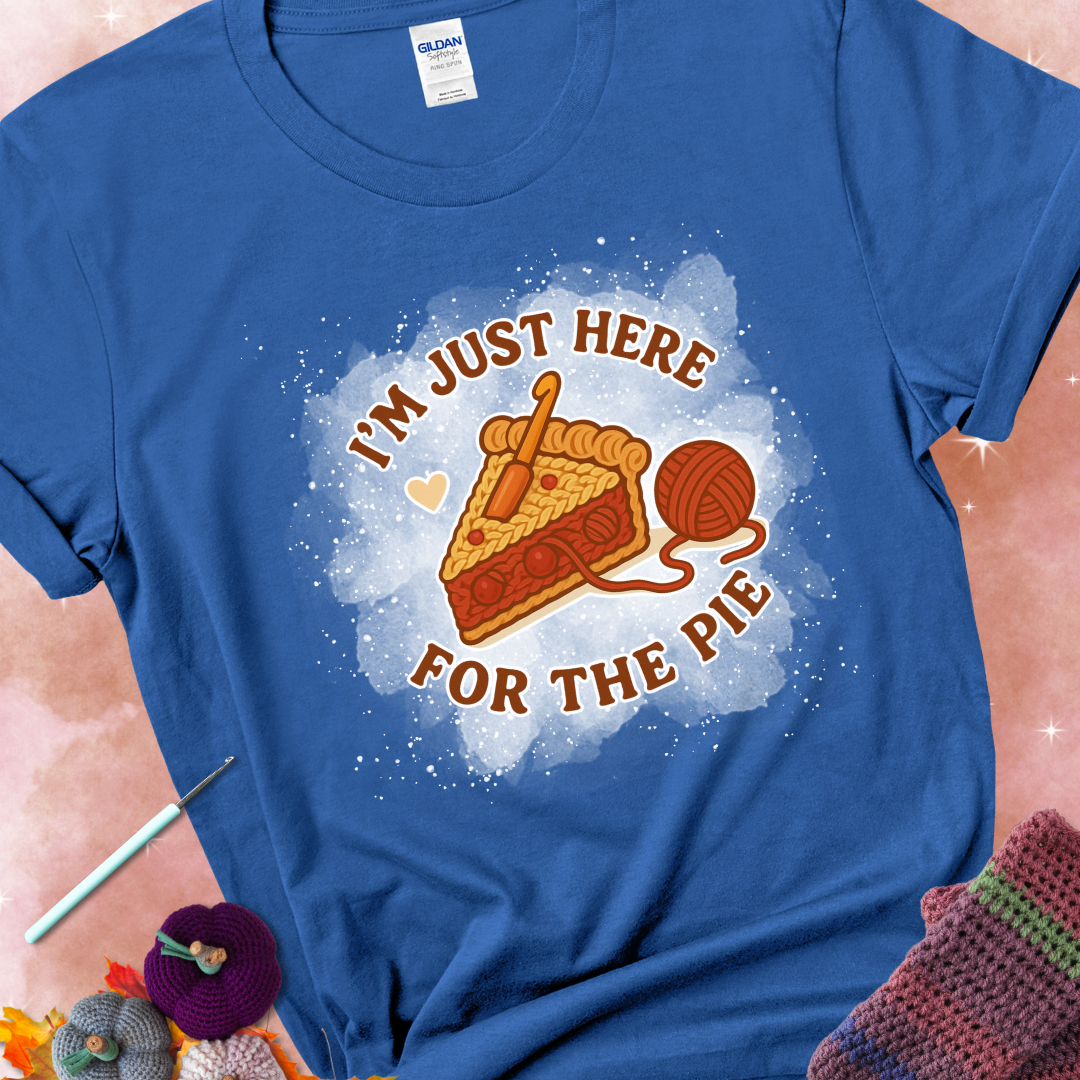 Royal t-shirt with a stitched slice of cherry pie with yarn-inspired filling and the phrase “I’m Just Here for the Pie” in red, beige, and cream.