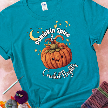 Tropical blue t-shirt with a smiling pumpkin crocheted with yarn texture, surrounded by stars and a crescent moon. Text reads “Pumpkin Spice & Crochet Nights.”