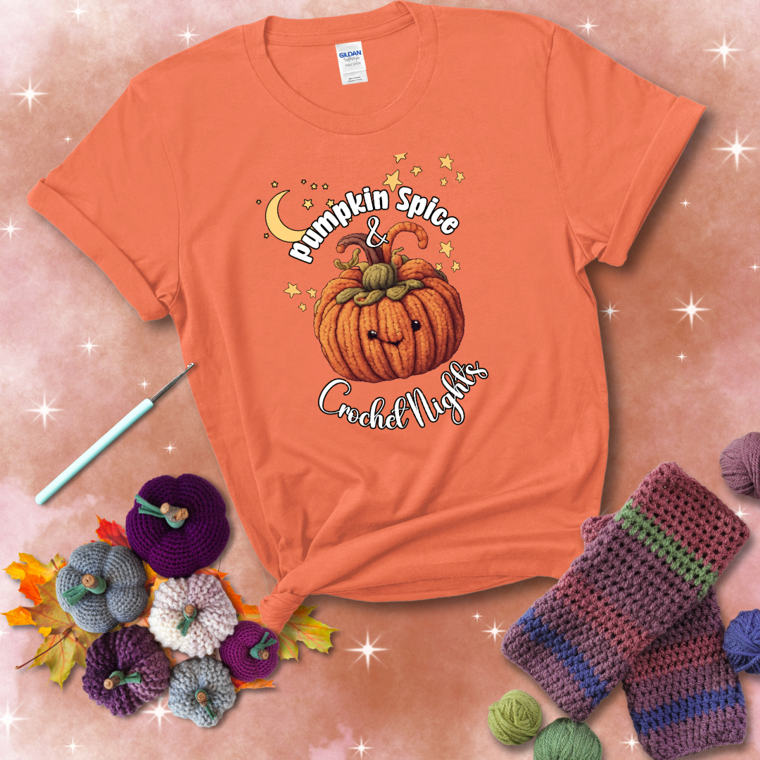 Smiling pumpkin crocheted with yarn texture, surrounded by stars and a crescent moon. Text reads “Pumpkin Spice & Crochet Nights” showing a light orange tee with a festive Fall background