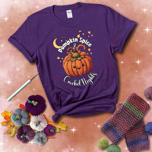 Smiling pumpkin crocheted with yarn texture, surrounded by stars and a crescent moon. Text reads “Pumpkin Spice & Crochet Nights” showing a purple tee with a festive Fall background