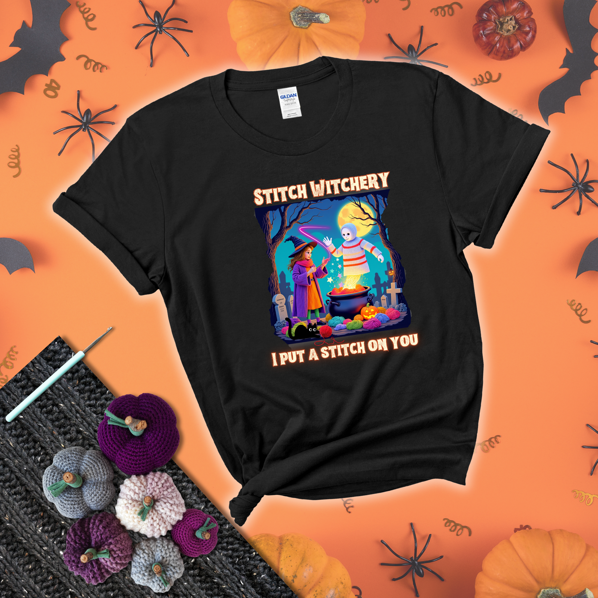 A Halloween scene with a young witch casting a yarn spell from a cauldron onto a floating crochet-ghost figure, under the phrase “I Put a Stitch on You” showing a black tee with a festive Halloween background