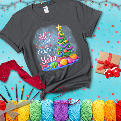 Bright Christmas tree decorated with yarn garlands, balls of yarn underneath, and the text “All I Want for Christmas is Yarn” in festive fonts, showing a dark grey tee with a festive Christmas background