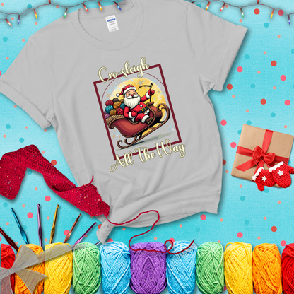Jolly Santa rides a sleigh overflowing with colorful yarn balls, surrounded by sparkles and holiday cheer. Text reads “Cro-sleigh All the Way" showing a light grey tee with a festive Christmas background