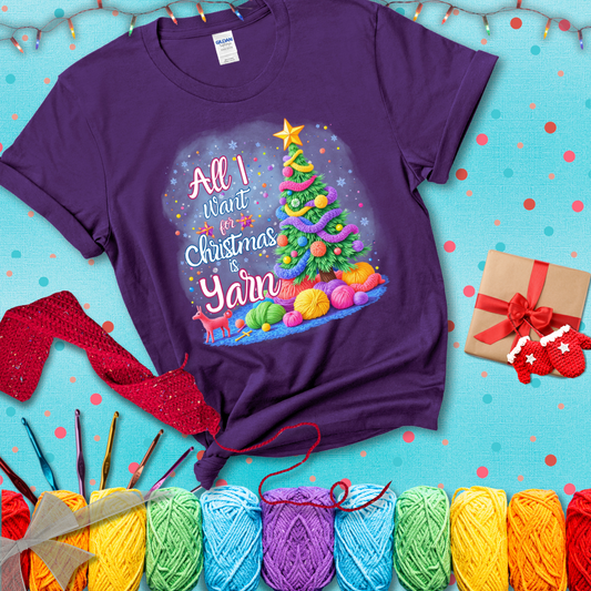 Bright Christmas tree decorated with yarn garlands, balls of yarn underneath, and the text “All I Want for Christmas is Yarn” in festive fonts, showing a purple tee with a festive Christmas background
