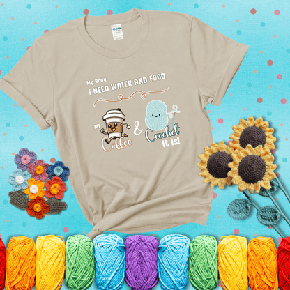 Design reads “My body: I need water and food. Me: Coffee & Crochet it is,” with a smiling coffee cup and yarn ball characters showing a beige tee with a teal sunflower background