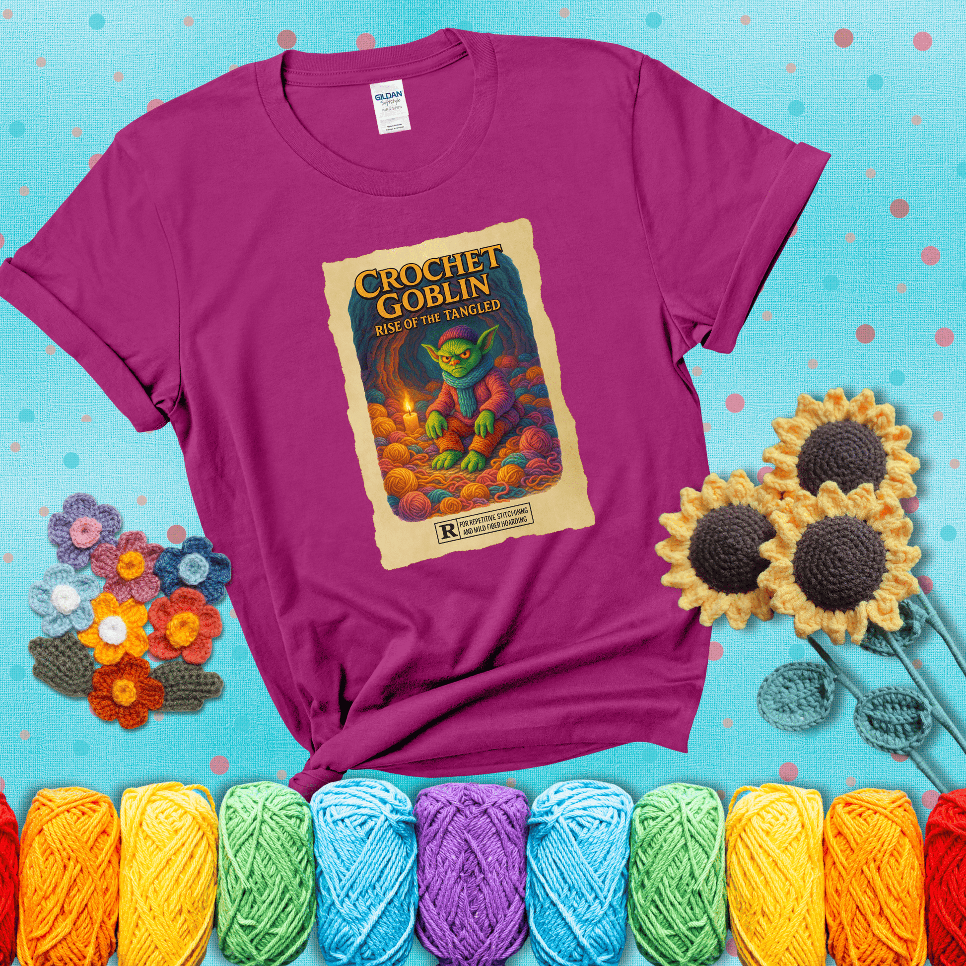 Crochet goblin surrounded by chaotic yarn stash in a cave-like lair. Text reads: “Crochet Goblin: Rise of the Tangled.” A funny fantasy-style tee for yarn hoarders and goblin-mode crafters. showing a magenta tee with a teal sunflower background