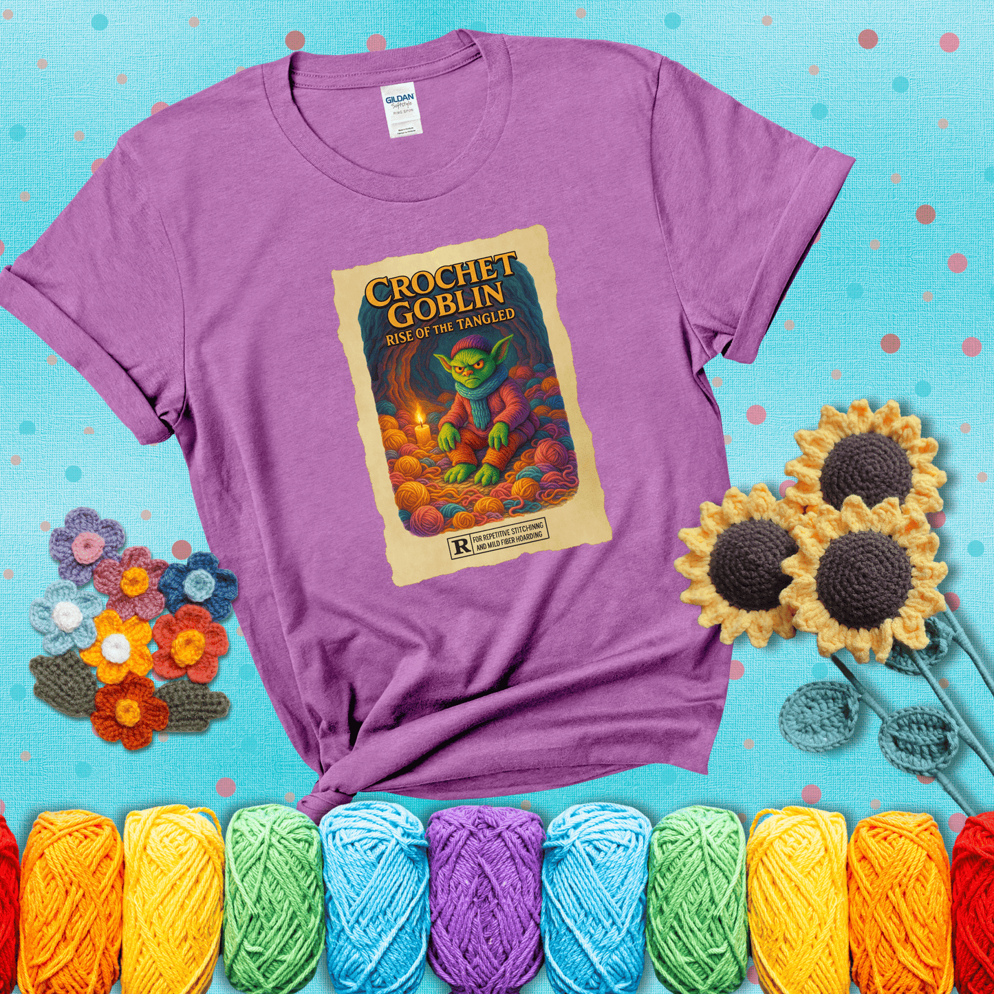 Crochet goblin surrounded by chaotic yarn stash in a cave-like lair. Text reads: “Crochet Goblin: Rise of the Tangled.” A funny fantasy-style tee for yarn hoarders and goblin-mode crafters. showing a light purple tee with a teal sunflower background