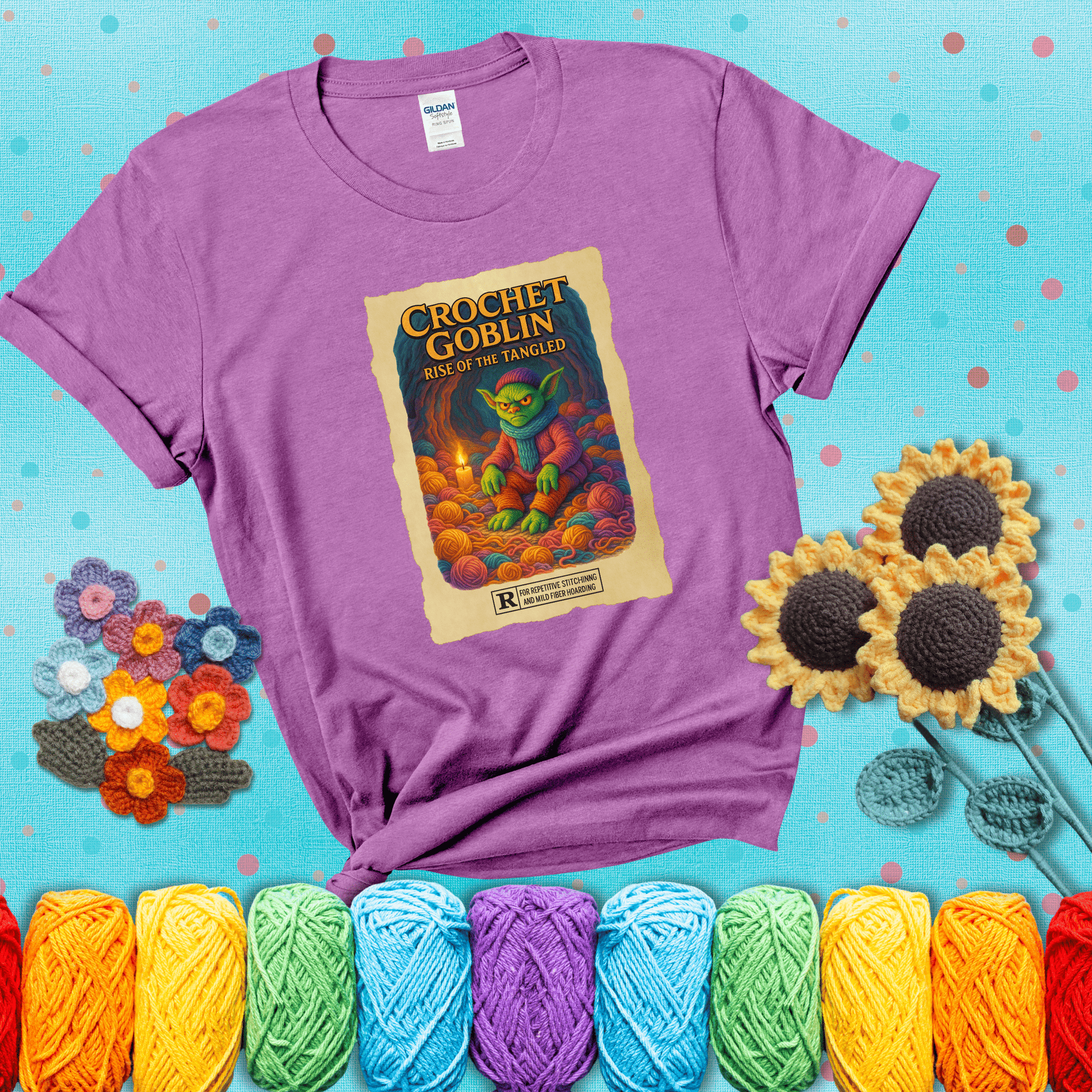 Crochet goblin surrounded by chaotic yarn stash in a cave-like lair. Text reads: “Crochet Goblin: Rise of the Tangled.” A funny fantasy-style tee for yarn hoarders and goblin-mode crafters. showing a light purple tee with a teal sunflower background