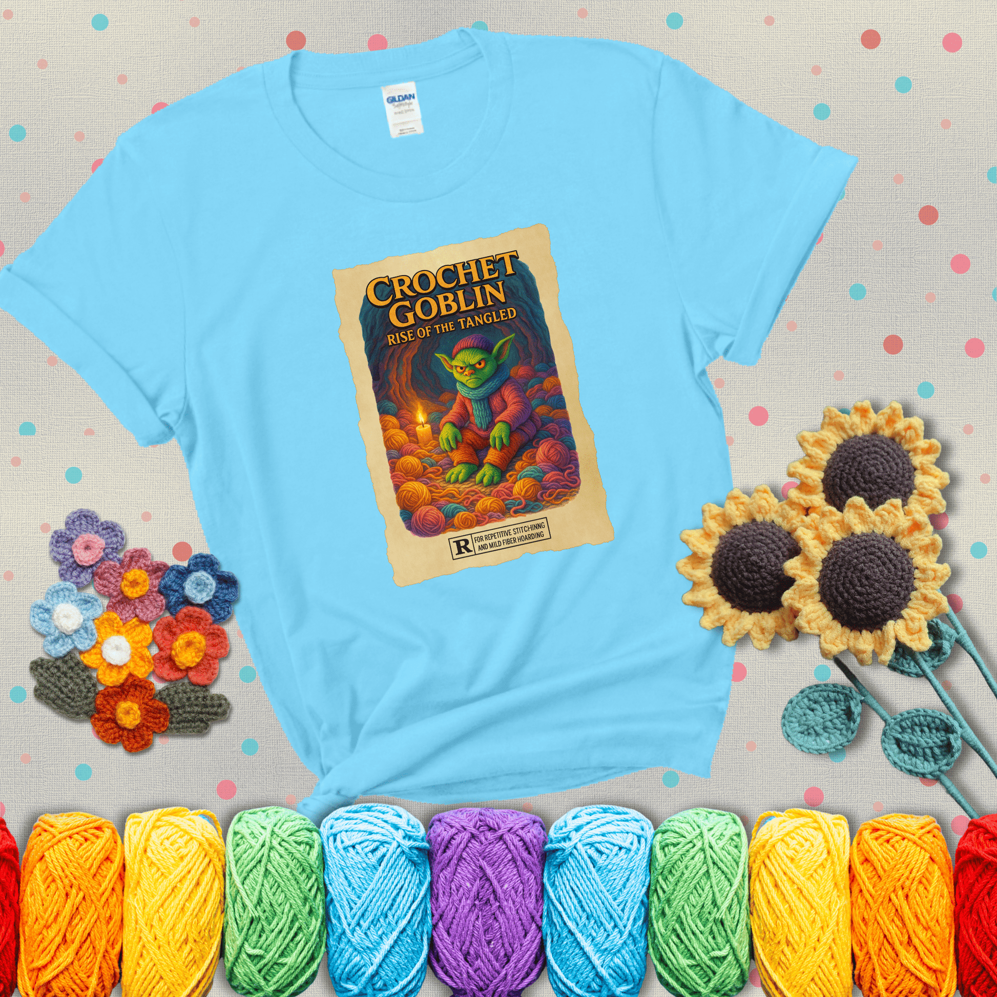 Crochet goblin surrounded by chaotic yarn stash in a cave-like lair. Text reads: “Crochet Goblin: Rise of the Tangled.” A funny fantasy-style tee for yarn hoarders and goblin-mode crafters. showing a light blue tee with grey sunflower background