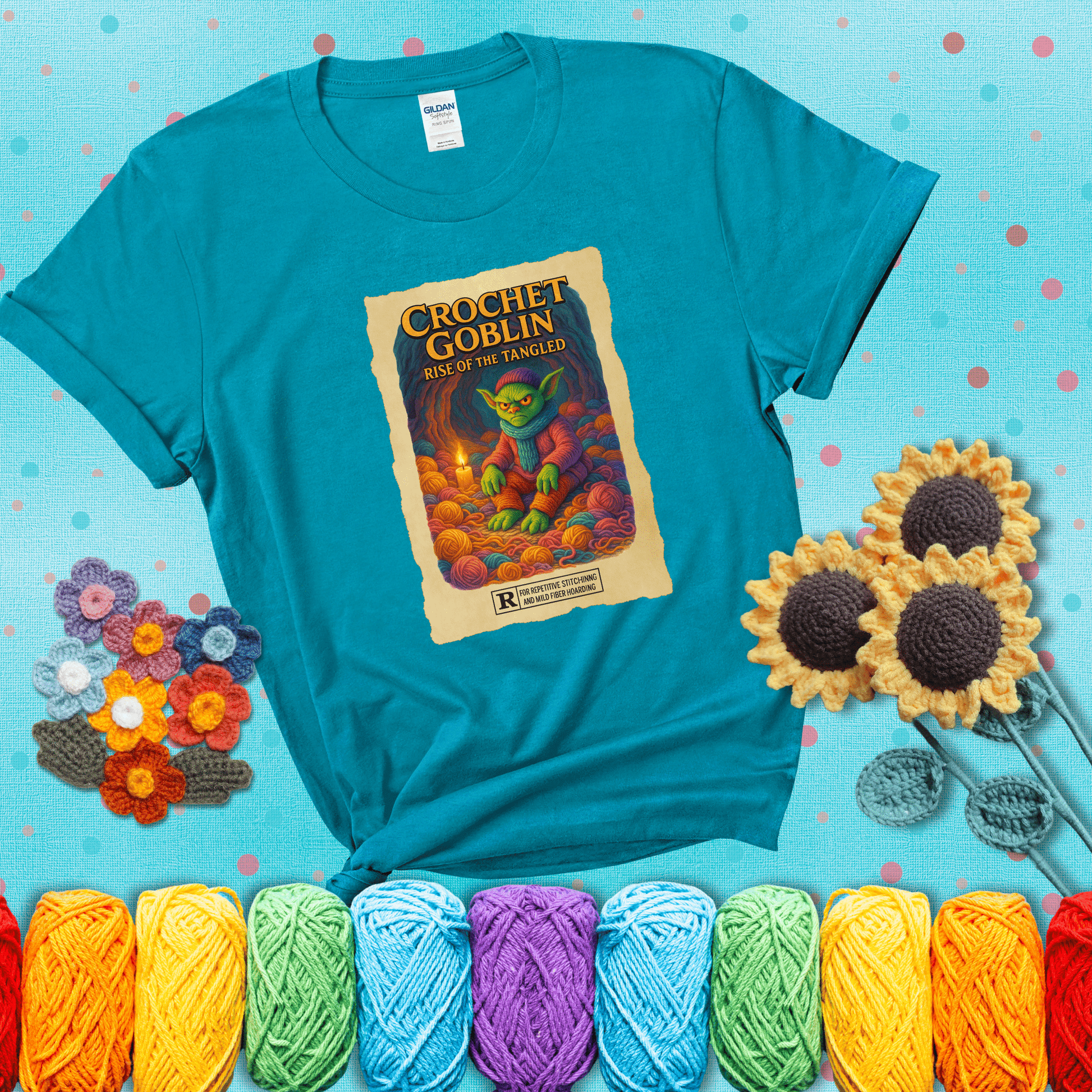 Crochet goblin surrounded by chaotic yarn stash in a cave-like lair. Text reads: “Crochet Goblin: Rise of the Tangled.” A funny fantasy-style tee for yarn hoarders and goblin-mode crafters. showing a blue-green tee with a teal sunflower background