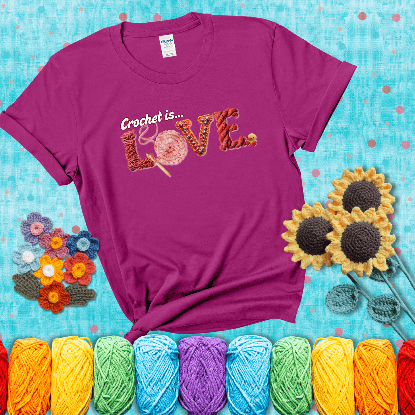 The word "LOVE" spelled with different crochet textures and yarn in red tones, with the phrase “Crochet is…” above in script. showing a purple tee with a teal sunflower background