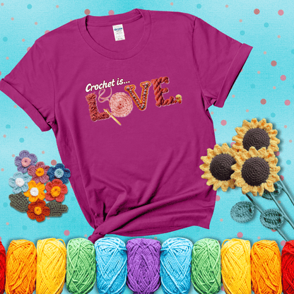 The word "LOVE" spelled with different crochet textures and yarn in red tones, with the phrase “Crochet is…” above in script. showing a purple tee with a teal sunflower background