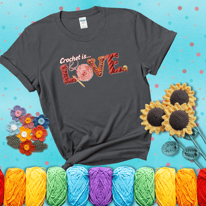 The word "LOVE" spelled with different crochet textures and yarn in red tones, with the phrase “Crochet is…” above in script. showing a pink tee with a teal sunflower background