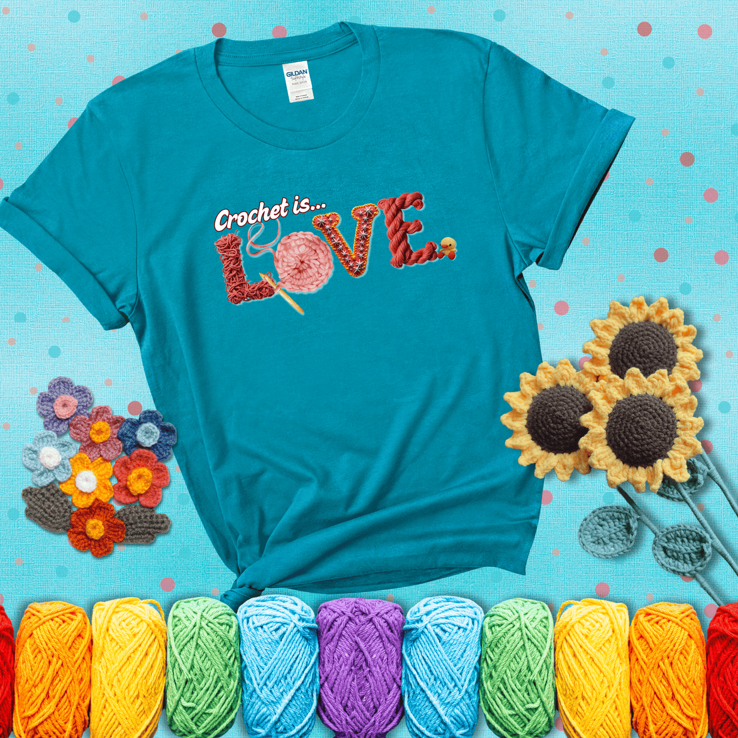 The word "LOVE" spelled with different crochet textures and yarn in red tones, with the phrase “Crochet is…” above in script. showing a beige tee with a teal sunflower background
