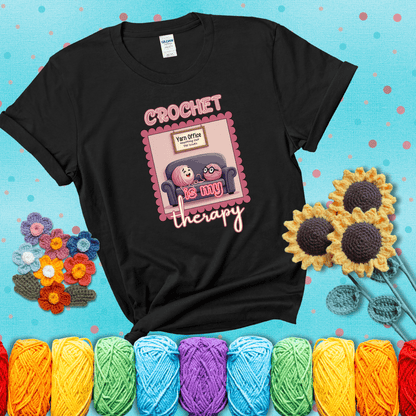 Simple text design with soothing yarn elements. Text reads: “Crochet is My Therapy.” A calming tee for fiber lovers who find healing in every stitch; showing a black tee with a teal sunflower background