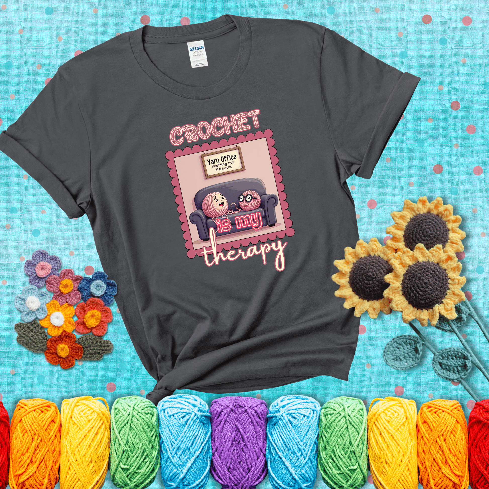 Simple text design with soothing yarn elements. Text reads: “Crochet is My Therapy.” A calming tee for fiber lovers who find healing in every stitch; showing a dark grey tee with a teal sunflower background