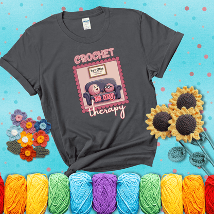 Simple text design with soothing yarn elements. Text reads: “Crochet is My Therapy.” A calming tee for fiber lovers who find healing in every stitch; showing a dark grey tee with a teal sunflower background