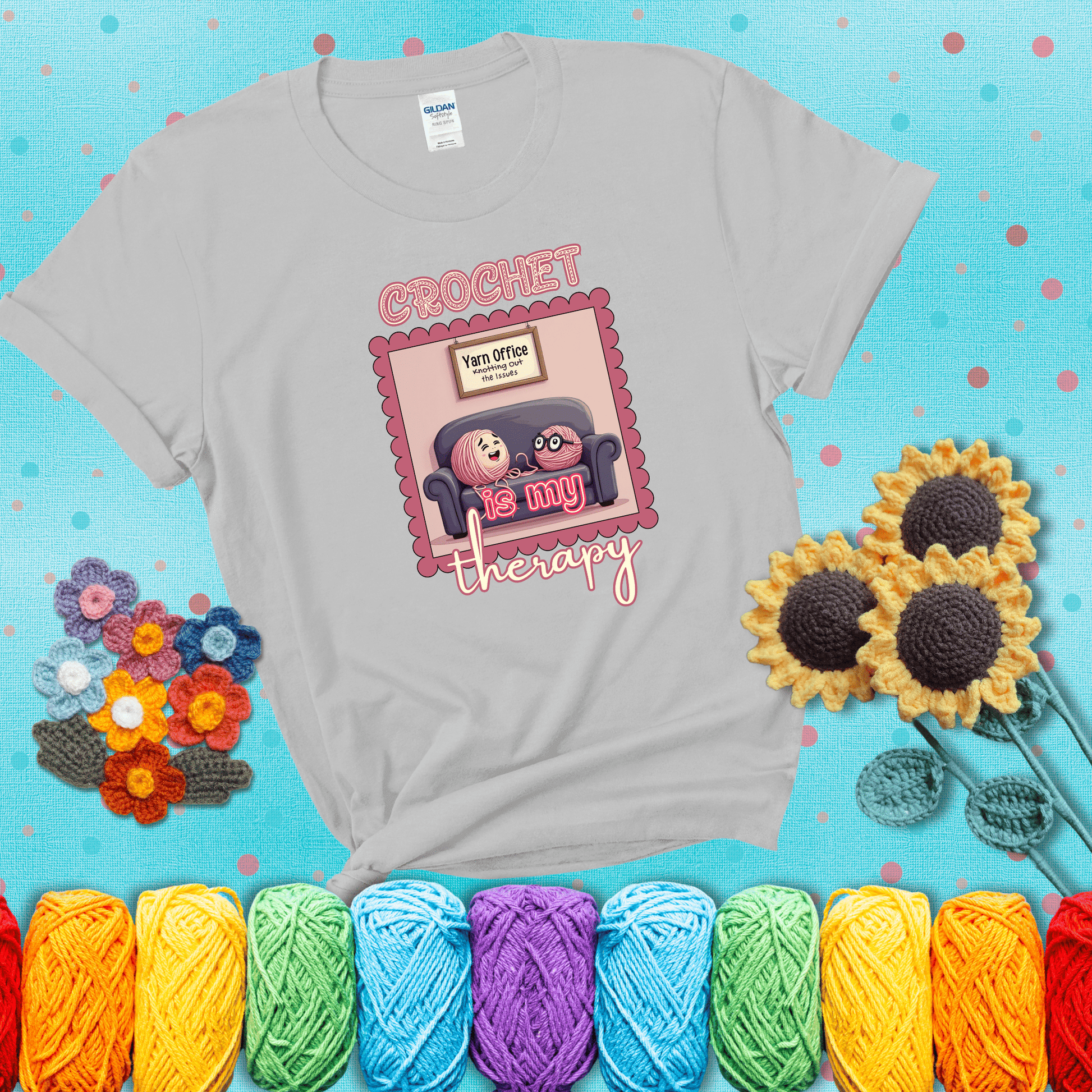 Simple text design with soothing yarn elements. Text reads: “Crochet is My Therapy.” A calming tee for fiber lovers who find healing in every stitch; showing a light grey tee with a teal sunflower background