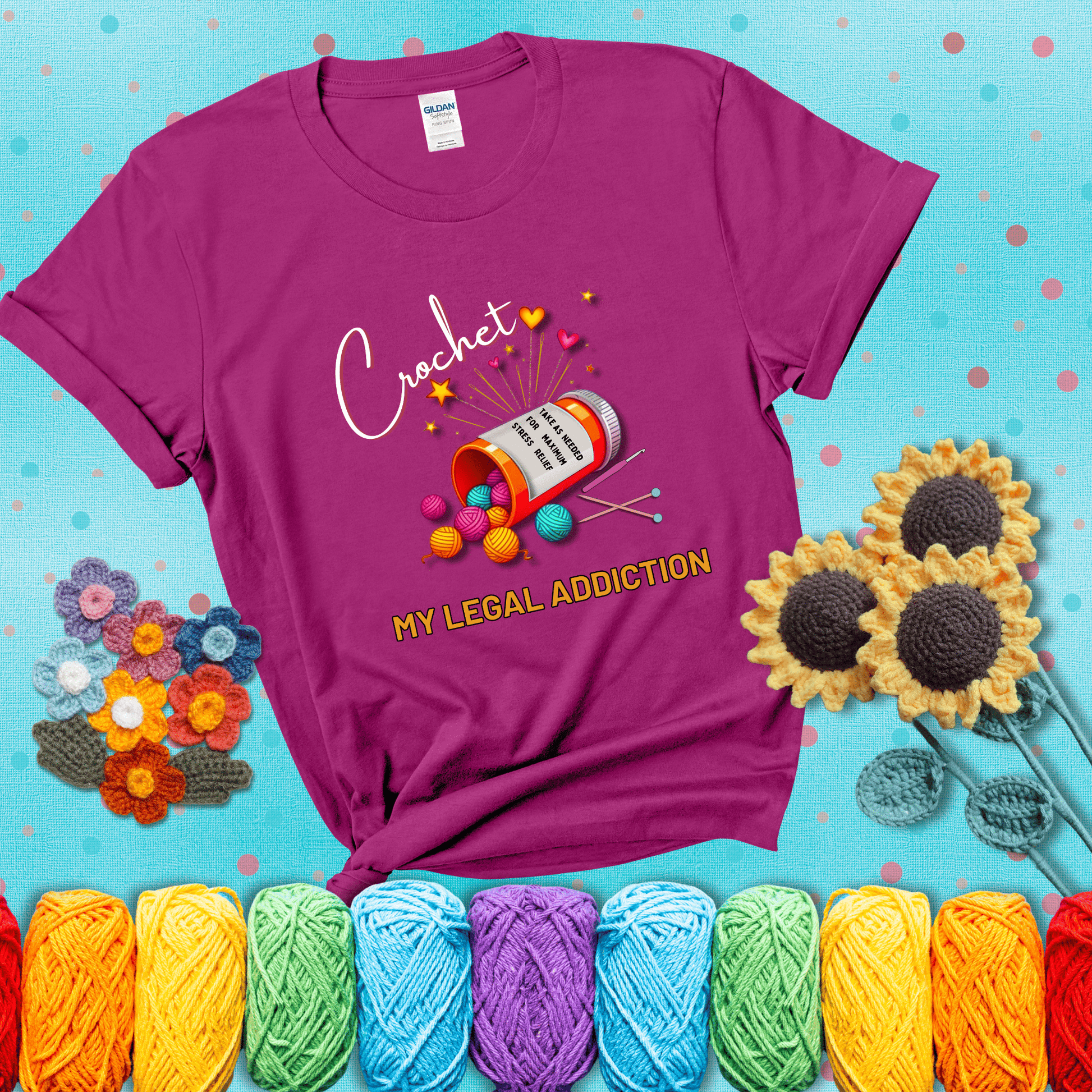 Orange prescription bottle spilling colorful yarn balls with text "Crochet – My Legal Addiction" and "Take as needed for maximum stress relief" showing a magenta tee with a teal sunflower background