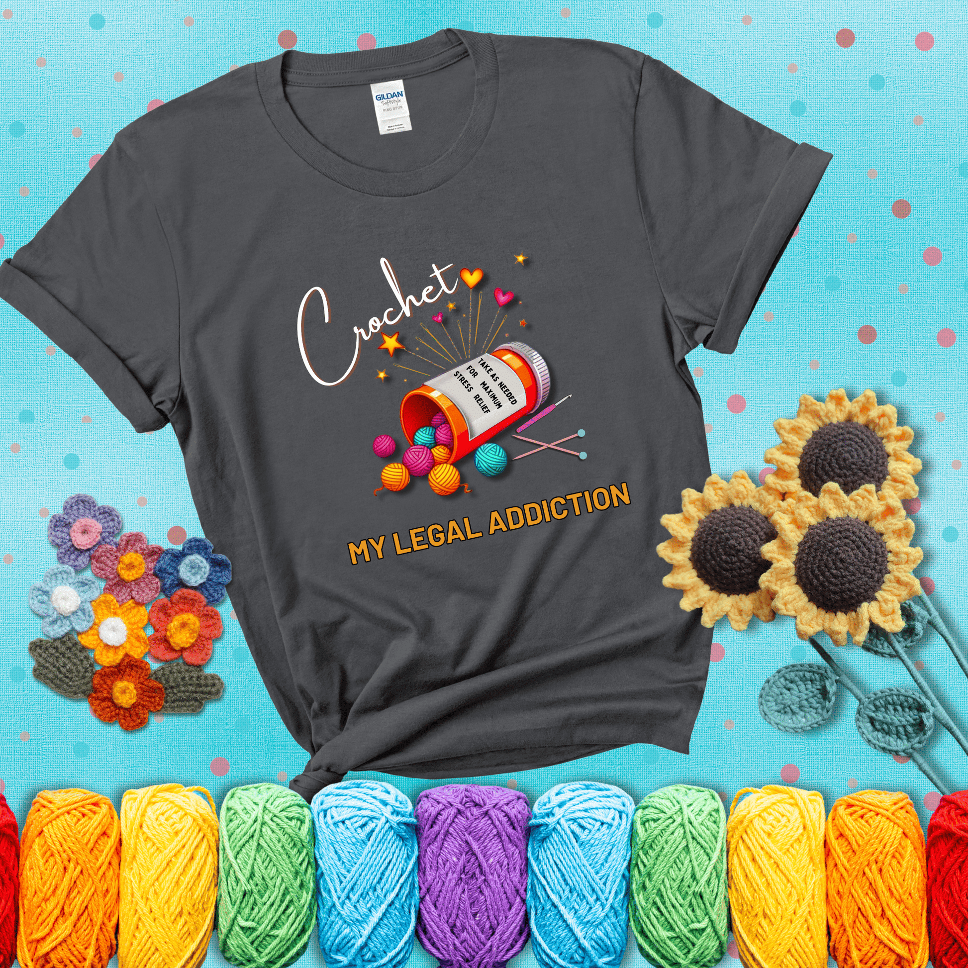 Orange prescription bottle spilling colorful yarn balls with text "Crochet – My Legal Addiction" and "Take as needed for maximum stress relief" showing a dark grey tee with a teal sunflower background