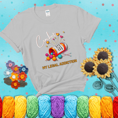 Orange prescription bottle spilling colorful yarn balls with text "Crochet – My Legal Addiction" and "Take as needed for maximum stress relief" showing a light grey tee with a teal sunflower background
